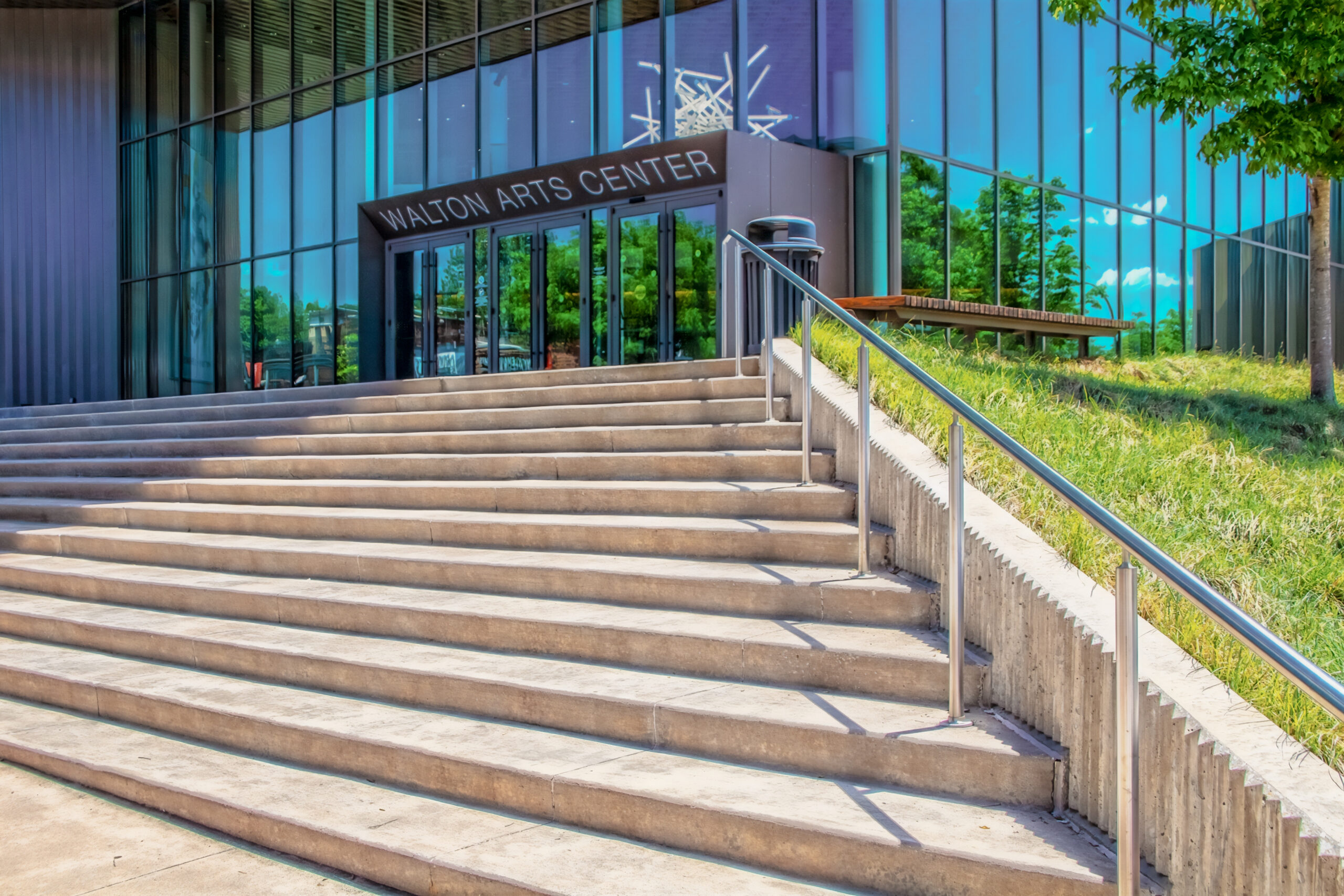 Fayetteville USA Walton Arts Center - View up steps to Entrance with reflections on side of building of trees and skies