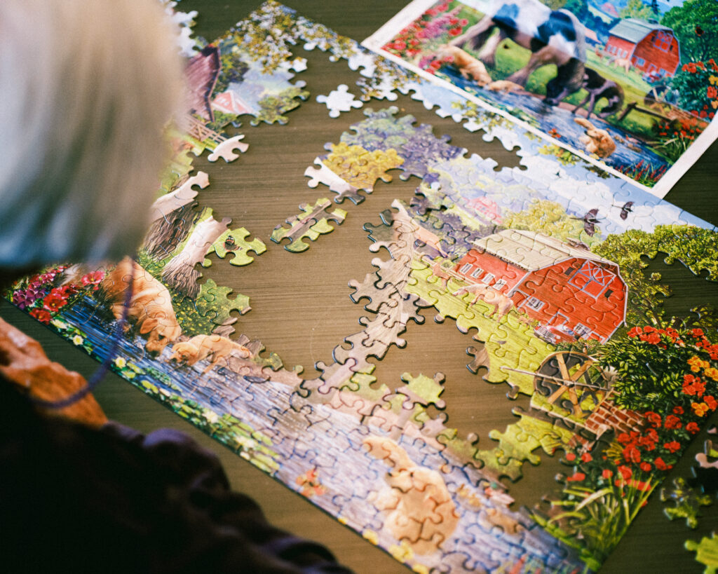 A woman works an elaborate puzzle at Grand Village, an independent living retirement community in Fayetteville, Arkansas.