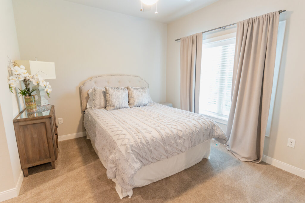 A well-appointed and welcoming bedroom at Grand Village, an independent living retirement community in Fayetteville, Arkansas.
